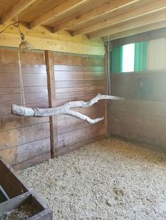 the inside of a barn with hay and wood