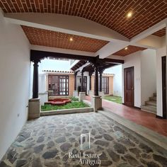 the inside of a house with stone flooring and an open porch area in front of it