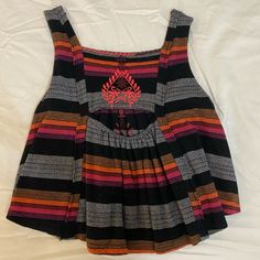 Sleeveless Black Top From Free People With Pink, Orange, And White Embroidery Details. Open Hole In Back And A Smock Fit. Never Worn But Missing Tags- Just Like New. Multicolor Sleeveless Smocked Summer Top, Multicolor Sleeveless Smocked Back Top, Summer Smock V-neck Top, Smock Top, White Embroidery, Embroidery Details, Free People Tops, Smocking, Free People