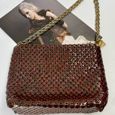 This vintage Whiting & Davis handbag from the 1970s is a must-have for any vintage fashion lover. Made from tortoiseshell mesh, this shoulder bag is both stylish and practical. The red/brown tones of the mesh give it a unique and timeless look. This original piece is in excellent condition and has been well preserved. It features the Whiting & Davis logo on the inside and is made in the United States. Perfect for any occasion, this bag is a statement piece that is sure to turn heads.  All mesh t Vintage Red Rectangular Shoulder Bag, Red Vintage Square Bag, Vintage Brown Evening Bag For Party, Evening Brown Shoulder Bag With Chain Detail, Evening Brown Shoulder Bag With Chain, Vintage Brown Bag With Chain Strap, Red Vintage Shoulder Bag With Gold-tone Hardware, Vintage Gold Shoulder Bag With Chain Strap, Vintage Crossbody Bag With Chain Strap