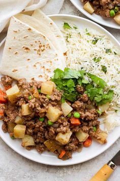 two plates filled with rice, meat and veggies next to tortillas