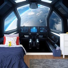 a bedroom with a view of the earth from inside a space station wallpaper mural