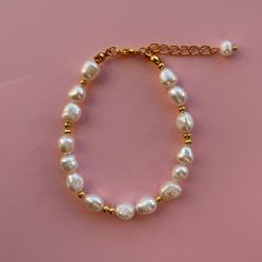 "Beautiful Handmade beaded genuine cultured freshwater Pearl bracelet with gold accents   7inch bracelet is photographed. I recommend choosing a length that is 0.5\"-1\" larger than your exact wrist size Pearl shape/size will vary from image shown Clasp and chain are stainless steel PACKAGING  This will come in a little organza gift bag so make the perfect present!  CARE OF ITEM Avoid contact with water/liquids as this may cause tarnishing to wire And clasp" Everyday White Pearl Beaded Bracelets, Classic White Pearl Bracelet With Gold Beads, Handmade White Pearl Bracelet For Everyday, White Beaded Bracelets With Pearl Drop, Classic Pearl Bracelet With Gold Beads For Gift, Classic Pearl Bracelet With Gold Beads As Gift, Handmade Dainty Gold Pearl Bracelet, Dainty Handmade Gold Pearl Bracelet, Gift Pearl Bracelet With Gold Round Beads