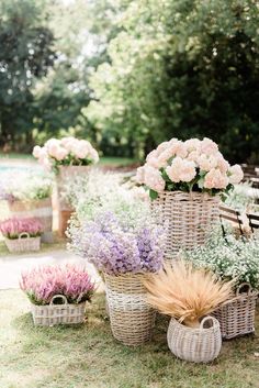 baskets filled with flowers sitting on top of a grass covered field