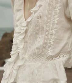 The Top Eldoris is crafted from the softest organic cotton voile, providing breathable comfort for all-day wear. Its Victorian-inspired design features a plunging V-neckline and cascading lace-trimmed ruffles for a touch of elegance. The intricate embroidery at the yoke and back adds a delicate and feminine touch, while the cinched waist and subtle peplum create a flattering silhouette. Perfect for any occasion, this top exudes charm and sophistication. Brentwood Country Mart, Enchanted Garden Wedding, Wedding Gown Simple, Intricate Embroidery, Mini Dress Casual, Lace Inset, Cotton Voile, Shop Maxi Dresses, Pin Tucks