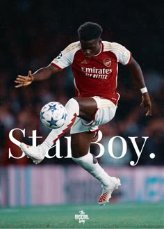 a young man kicking a soccer ball on top of a field with the words stay boy