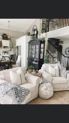 a living room filled with furniture next to a staircase