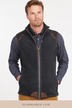 The Barbour Mens Langdale Fleece Gilet is a lightweight, versatile men's fleece bodywarmer. This warm gilet is made from super-soft fleece and styled with a zip-through front, stand collar and contrast binding to the collar edge and armholes. Internal drawcords allow the hem to be pulled in for additional protection from drafts, and the two-way zip features a Barbour-branded ring pull and a subtle flag label to the seam. Practical for use all year round, it's perfect for layering under a jacket. Fleece Gilet, Navy Bag, Mens Fleece, Dog Coats, Mens Navy, Puma Jacket, Stand Collar