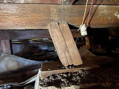 the inside of an old house that has been gutted with wood and other debris