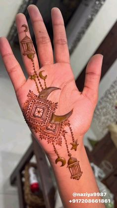 a person's hand with henna tattoos on it