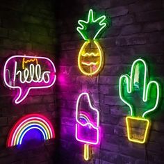 neon signs on the side of a brick wall that say hello and have different types of speech bubbles