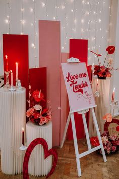 a valentine's day display with candles and greeting cards for someone to write on the easel