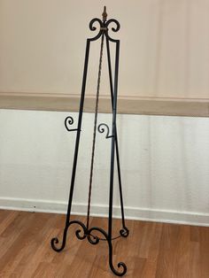 an iron and wood coat stand on wooden floor