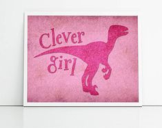 a pink greeting card with the words clever girl and a dinosaur silhouette on it's back