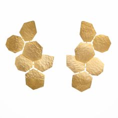 The Gilded Honeycomb Earrings are a striking example of geometric elegance, seamlessly blending modern design with natural inspiration. Crafted with 24k gold-plated hexagonal shapes arranged in a honeycomb pattern, these Gilded Honeycomb Earrings feature a hammered texture that adds a unique and sophisticated touch. Ideal for both special occasions and everyday wear, these earrings stand out as a versatile accessory. Care and maintenance instructions:   Storage: Store each piece of jewellery individually in the original packaging or a soft pouch to prevent damage. Cleaning: Frequently polish your jewellery with a soft, lint-free cloth to maintain its original sparkling condition. Handling: Always put on jewellery last when dressing and remove it first before undressing to avoid exposure to Elegant Gold Hexagon Earrings, Modern Gold Hexagon Earrings, Honeycomb Earrings, Earrings Stand, Natural Inspiration, September Birthstone Jewelry, Earring Stand, August Birthstone Jewelry, July Birthstone Jewelry