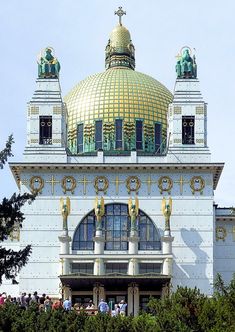 people are standing on the roof of a building with gold and white decorations around it