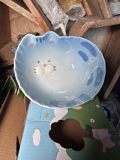 a cat shaped bowl sitting on top of a table