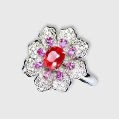 !!WOW!!  A STUNNING JEDI SPINEL!  Featured in a Diamond Couture Flower Ring. Bright orange-pink spinel measures 1.03ct, smaller, pear-shaped, light-violet tourmalines and diamond petals, all set in 18K white gold.  Size 7. 1.03ct natural Jedi Spinel and natural white South African diamonds, bright color, clean-crystal, good clarity. Shape: Oval. Cut: Excellent. Internationally certified natural Spinel, comes with International Jewelry Appraisal Certificate. Designer: unknown. White Gold Ruby Multi-stone Diamond Ring, White Gold Ruby Diamond Ring With Multi-stone, Diamond Multi-stone Flower Ring, Flower Shaped Diamond Ring With Multi-stones, Flower Shaped Diamond Rings With Gemstones, Fine Jewelry Flower-shaped Multi-stone Rings, Fine Jewelry Flower Cluster Ring With Gemstone, Luxury Flower-shaped Rings With Center Stone, Exquisite Flower Shaped Gemstone Rings