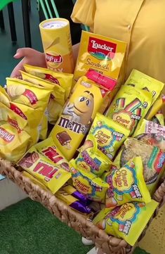 a person holding a basket full of snacks