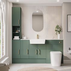 a white toilet sitting next to a bathroom sink under a mirror on top of a wall