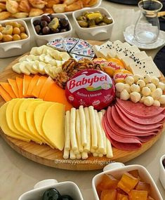 an assortment of cheeses, crackers and meats on a platter