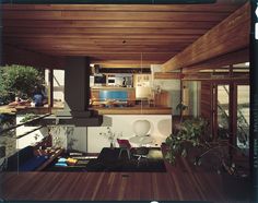 the interior of a house with wood floors and walls, including an open floor plan