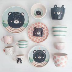 there are many plates and cups with bears on them