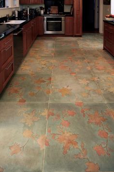 a kitchen with wood cabinets and tile flooring that has fallen leaves on the floor