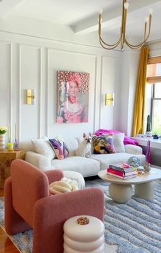 a living room filled with furniture and a painting on the wall