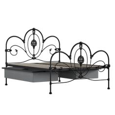 an iron bed frame with a mattress on it's side and headboard in the middle