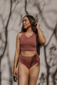 Pink Cove's Joy Bottoms in Mauve. These high waisted swim bottoms provide full coverage, ideal for a modest bikini look. Perfect for stylish yet modest swimwear, suitable for women and cute bikinis for teens this summer. The aesthetic swimsuit design makes these cute bathing suits a favorite. Shop our collection to find your new swimwear staple and stay stylish. Swimsuit Inspiration