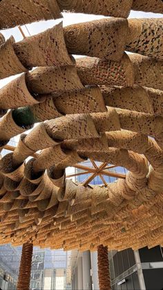 an art installation made from woven straws in a building