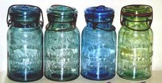 four glass jars are lined up in a row