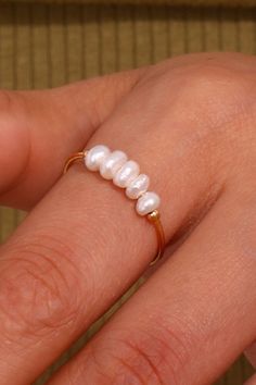 Adorn your finger with this lovely Organic Pearl Beaded Gold Ring! Perfect for adding a touch of sophistication to your look, this stacking ring features a pearl beaded design on a gold band. 

>> Organic Pearl Beaded Gold Ring: https://pinealvisionjewelry.com/products/organic-pearl-gold-ring Gold Rings With Pearl, Elegant Gold Pearl Ring For Wedding, Pearl Rings In Gold Vintage, Handmade Gold Pearl Ring, Gold Pearl Beaded Rings, Glitter Hair Gel, Pearl Design, Affordable Jewelry, Steel Jewelry