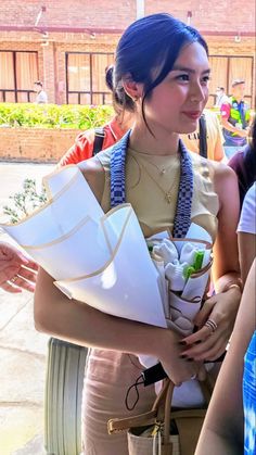 a woman is holding several bags in her hands