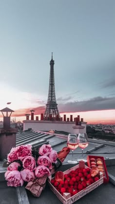 the eiffel tower is in the background with flowers and fruit on the roof