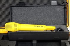 a yellow blow dryer sitting inside of a case