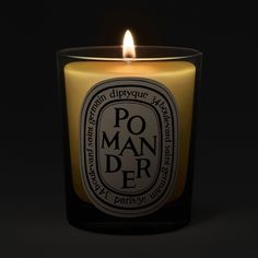 a candle with the words po mander written on it in black and white lettering