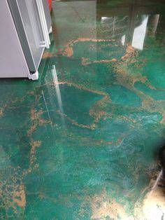 the floor is covered in green and gold paint, with an area that looks like it has been stained