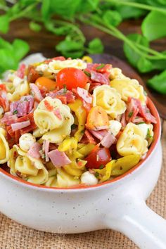 a bowl filled with pasta salad on top of a table