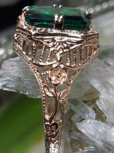 Natural Green Emerald 10k or 14k Rose Gold RingLovely Rectangle Design#D148 Make heads turn and stand out with this gorgeous piece of jewelry! This Edwardian reproduction filigree ring is made from rose gold and features an emerald cut high quality natural emerald gemstone measuring 9mm by 7mm. From the beautiful intricate floral daisy design to the inside of the band marked 10K or 14K for gold – this ring will take your look to the next level! Look no further than this exquisite vintage-inspire Classic Rose Gold Emerald Jewelry, Rectangular Rose Gold Jewelry With Prong Setting, 14k Rose Gold Emerald Ring, Elegant 14k Rose Gold Jewelry With Emerald Cut, 14k Gold Rectangular Emerald Anniversary Ring, Elegant Rose Gold Emerald Ring In 14k, Art Deco Rectangular Emerald Ring For Anniversary, Elegant 14k Rose Gold Emerald Cut Jewelry, Elegant 14k Rose Gold Emerald Ring