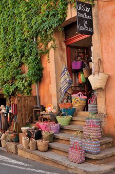 an orange building with lots of baskets on the outside and stairs leading up to it