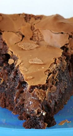 a piece of chocolate gooey cake on a blue plate with the title above it