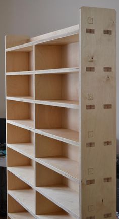 an unfinished bookcase is sitting in the middle of a room