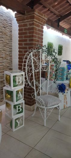 a white chair sitting on top of a tiled floor next to a brick wall and ceiling