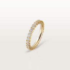 a yellow gold ring with small white diamonds on the inside and outside, set against a plain background