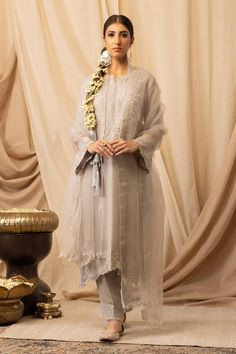 Silver pure organza silk straight-cut kurta with zardosi, resham and pearls embroidery. Comes with bamberg satin salwar and a dupatta.
Components: 3
Pattern: Embroidered
Type Of Work: Resham, Zardosi, Pearls
Neckline: Notched
Sleeve Type: Three quarter
Fabric: Kurta and Dupatta: Pure organza silk, Salwar: Bamberg satin
Color: Silver
Other Details: 
Elasticated waistband on pant
Attached lining
Length:
Kurta: 45 inches
Pant: 36 inches
Product Weight: 1 Kg
Model Height: 5ft 5inches, wearing size S Satin Salwar, Pearls Embroidery, Kurta And Dupatta, Pearl Embroidery, Satin Color, Set For Women, Straight Cut, Aza Fashion, Model Height