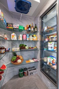 a refrigerator filled with lots of food next to a shelf full of fruit and vegetables