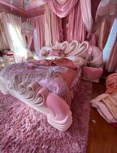 a bedroom with pink walls and carpeted flooring is pictured in this image, the bed has an elaborate design on it