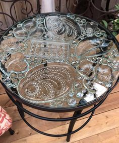 a glass table sitting on top of a wooden floor